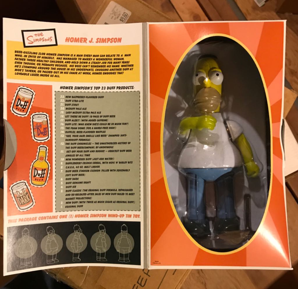 Simpsons: Homer Tin Action Toy - Rocket USA (The Simpsons) action figure collectible [Barcode 642063008007] - Main Image 1