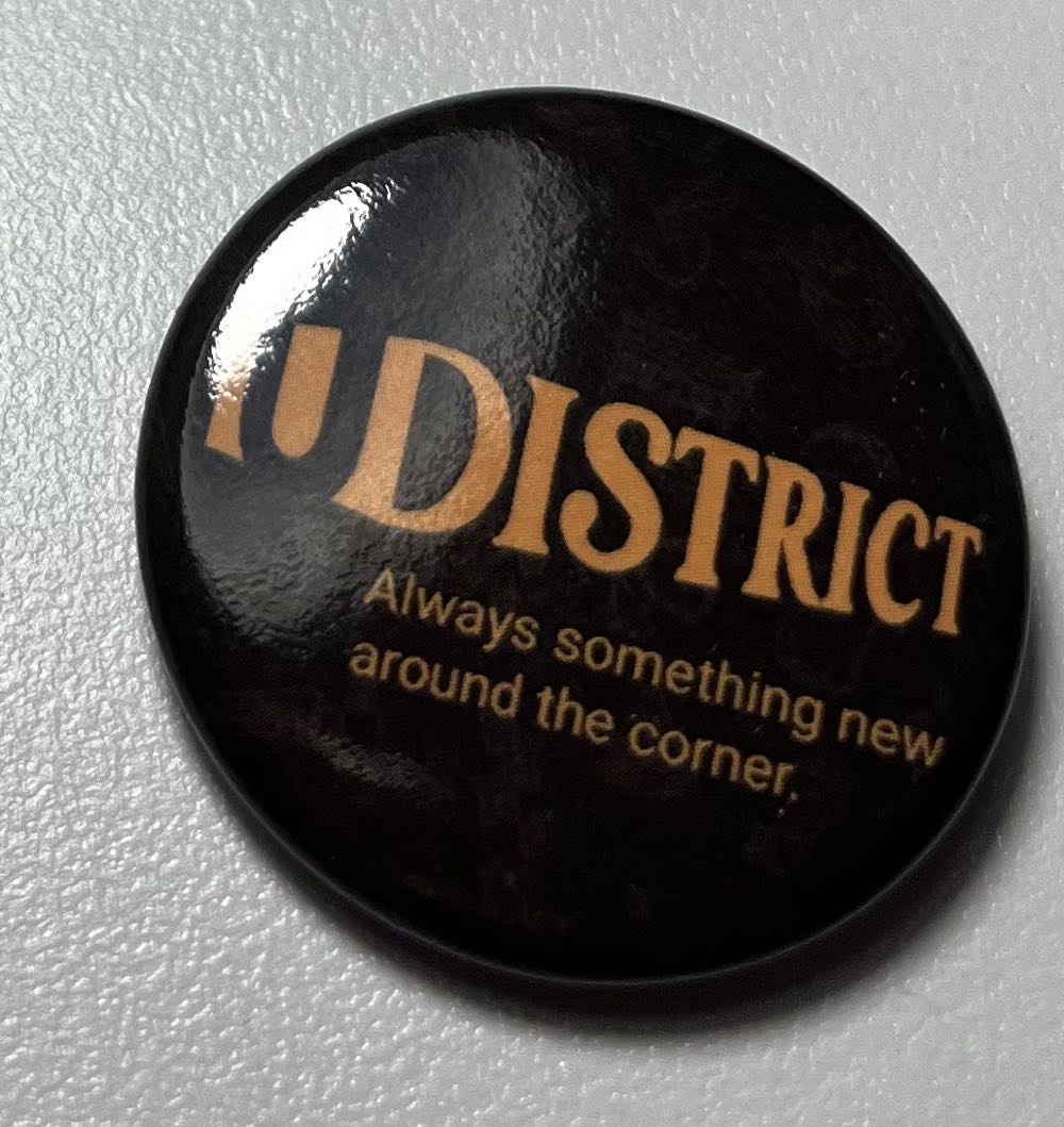 UDistrict Always Something New Around the Corner. - Button pin collectible - Main Image 1