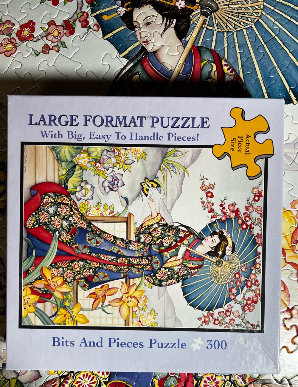 Maiden In The Garden - Bits & Pieces puzzle collectible [Barcode 704812107352] - Main Image 2