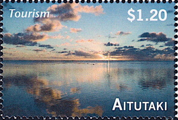 Sandy beach with leaning palm tree and island
