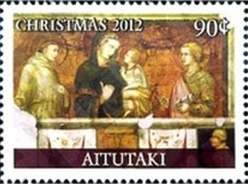 Looking over fence to sandy beach with two deckchairs