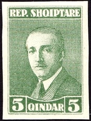 Miner with Jackhammer in Front of an Industrial Plant