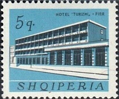 Hand holds book with pictures of Marx, Engels, Lenin, Stalin