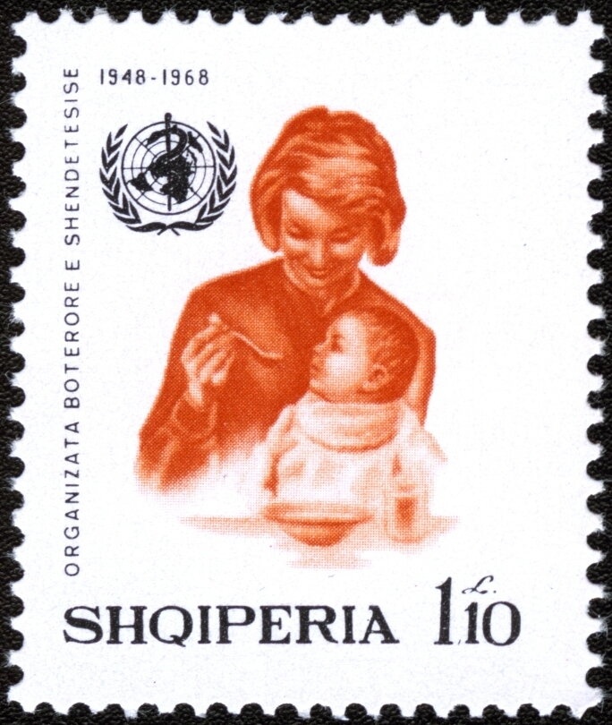 Albanian mother and nurse weighing infant