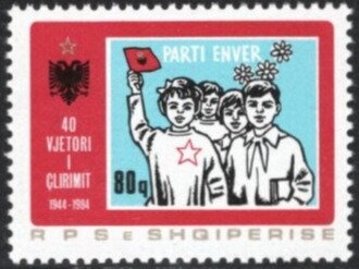 Costumed actress seated in chair