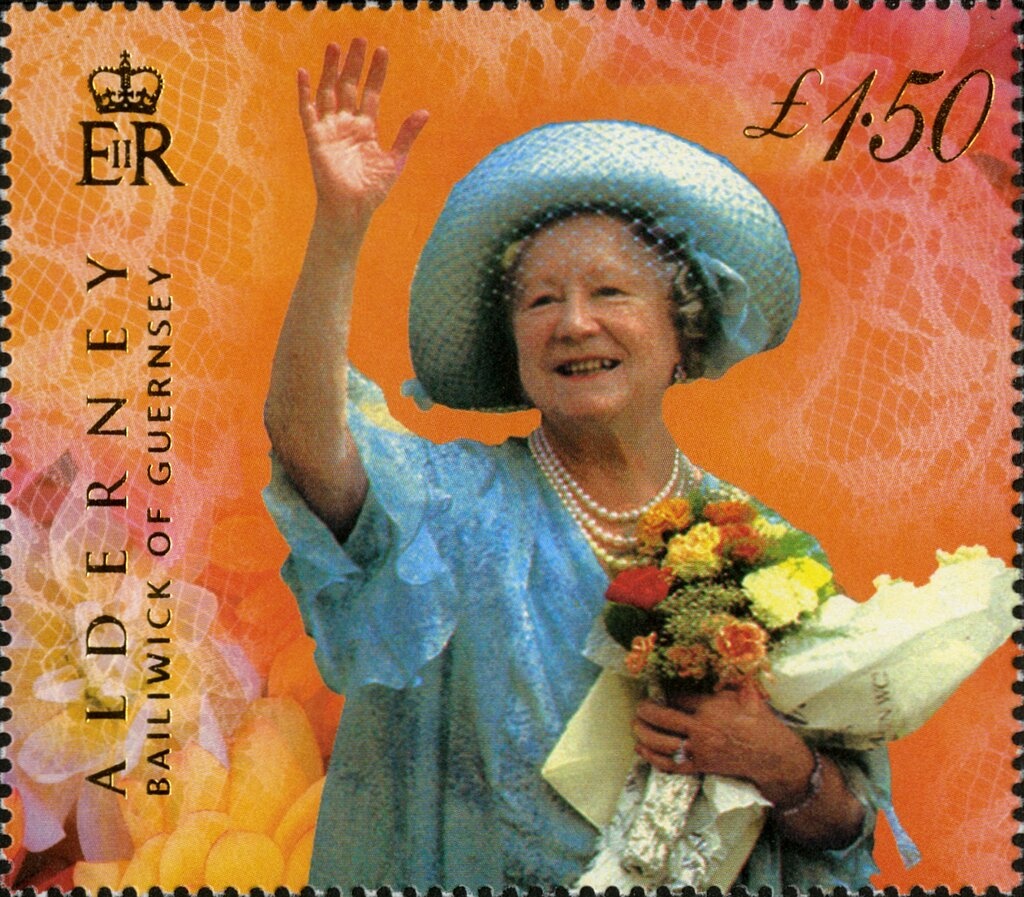 Hand holding quill pen and map of Europe